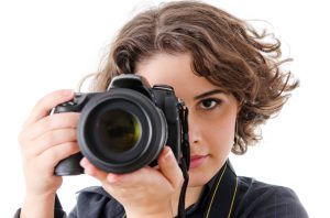 Woman photographer with camera, isolated on white